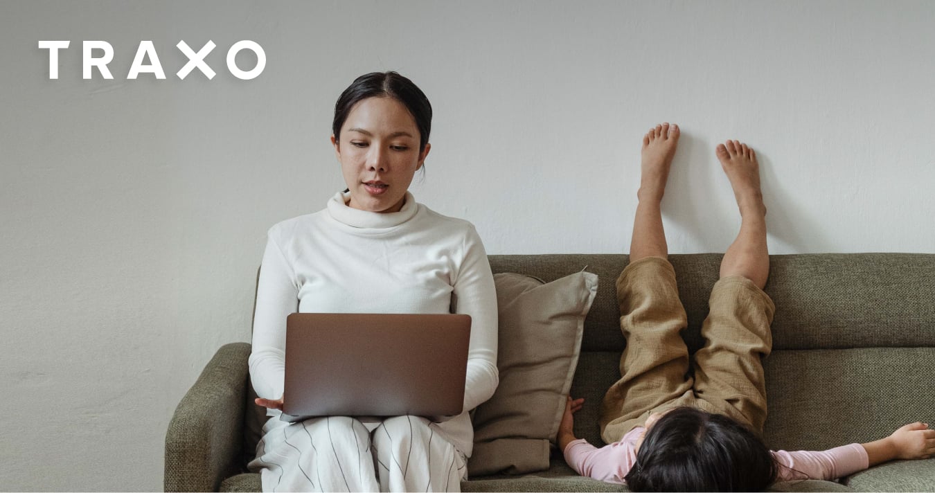 Mother working from home with her child | Traxo 2022 Work Trends Blog