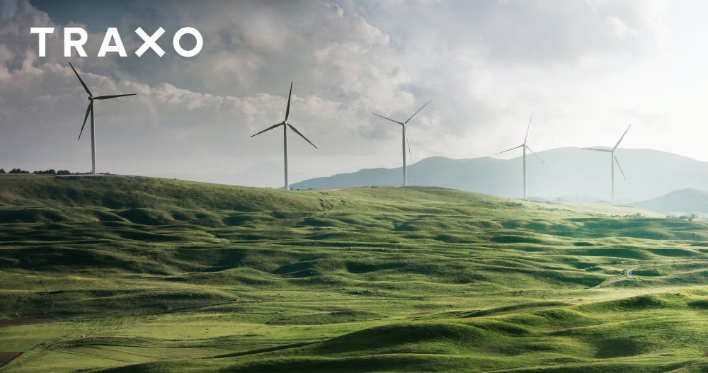 Wind turbines across rolling green hills